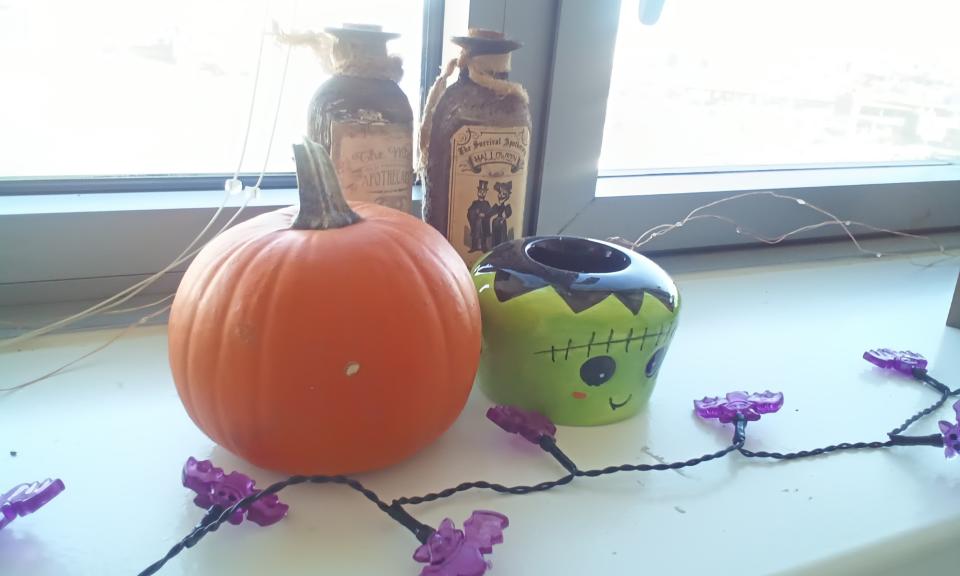 A sample photo from the Amazon Fire HD 8's rear camera, showing a small pumpkin and a Frankenstein-themed candle holder on a white window ledge.