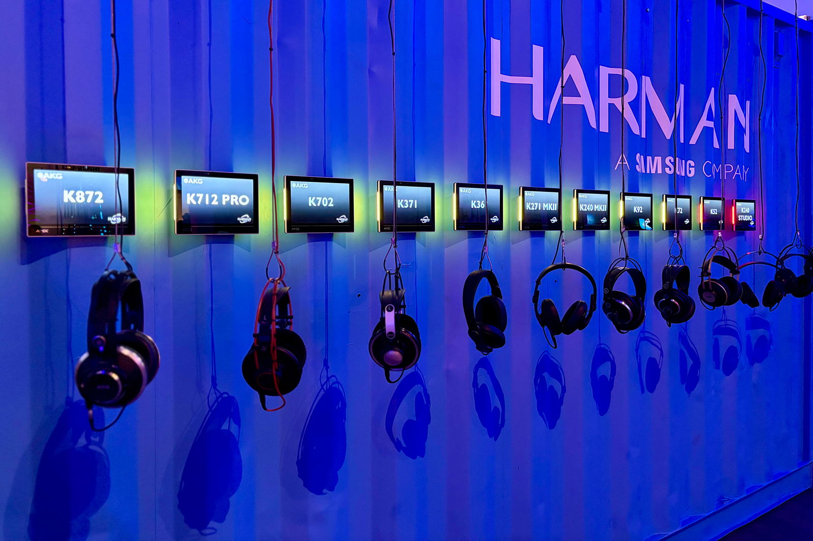 A series of AKG Headphones hanging on a wall in front of their model numbers inside of the Harman Experience Center in Los Angeles