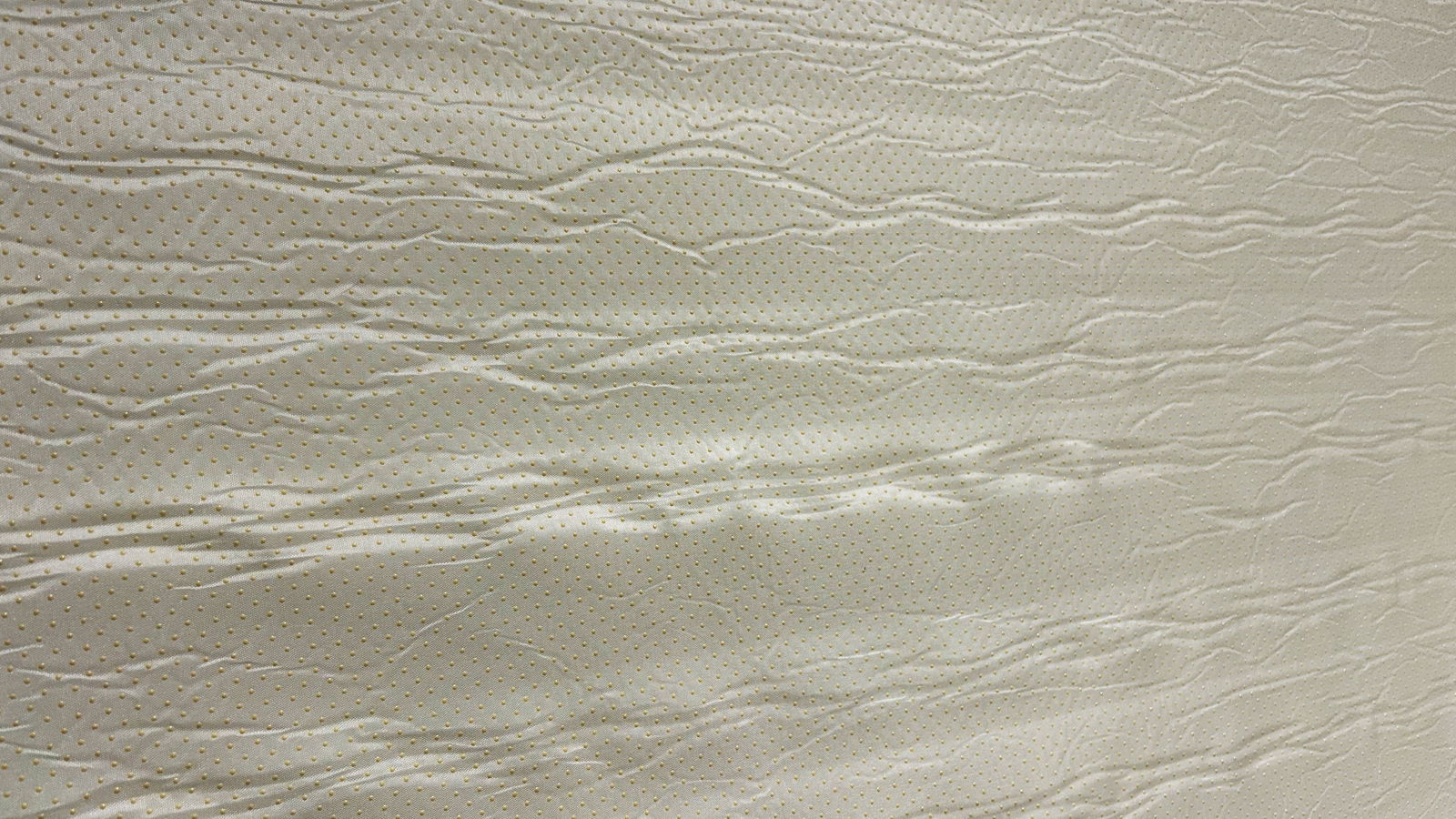 Bottom side of Valmori Hybrid II mattress depicting mattress cover and little yellow anti slip grip buttons