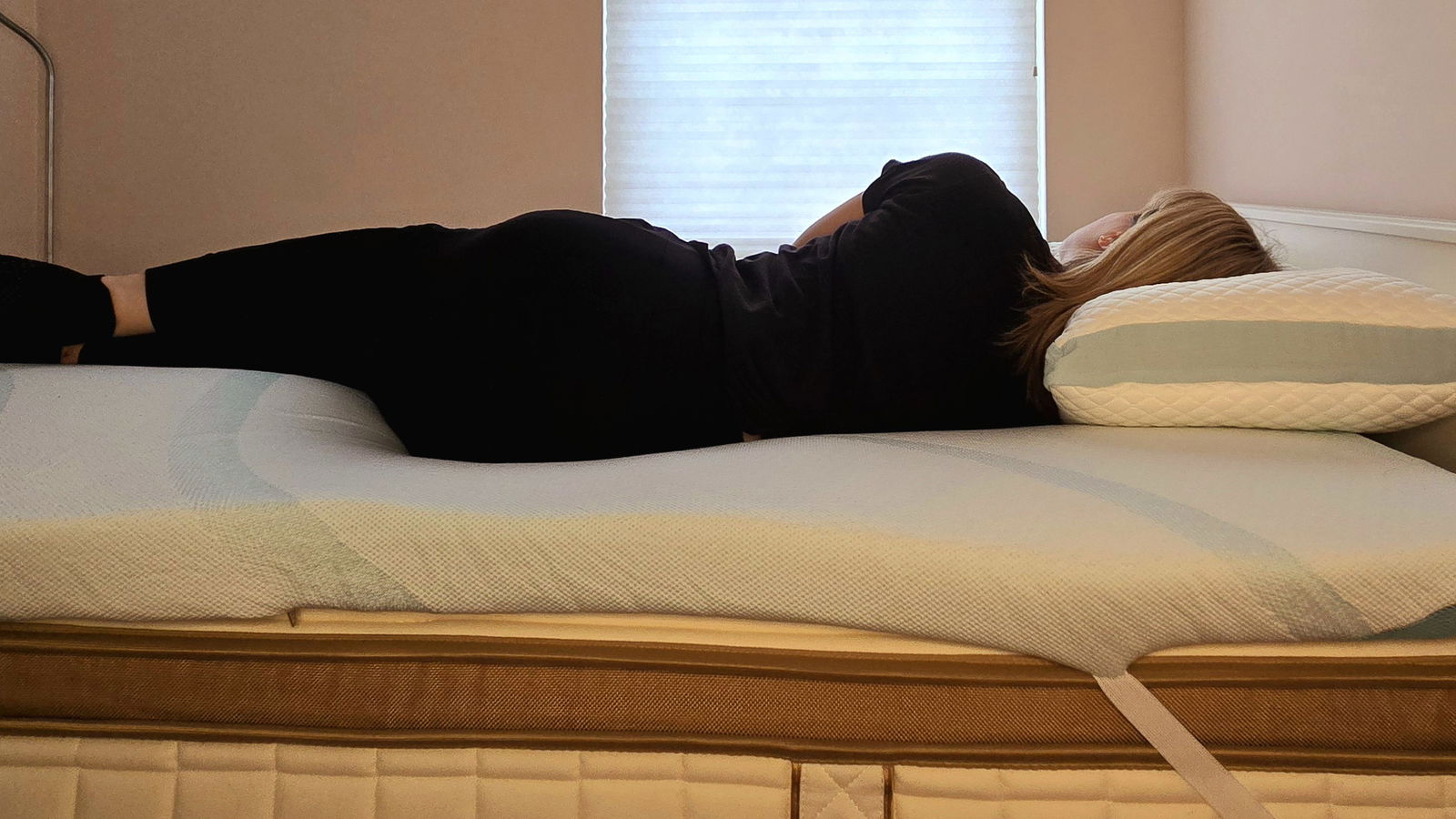 Our mattress tester sleeping on a twin-size Tempur-Adapt + Cooling Topper for the Tempur-Pedic Tempur-Adapt + Cooling Mattress Topper review