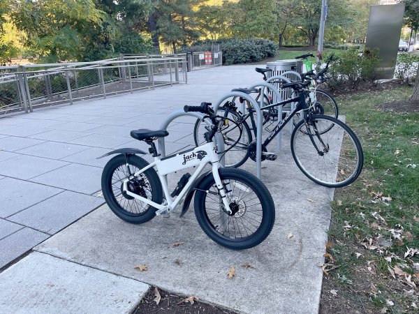  White JackRabbit XG commuter escooter on a bike rack to show scale