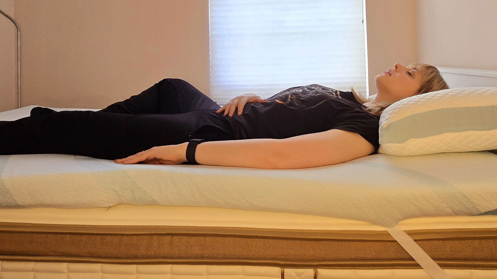 Our mattress tester sleeping on a twin-size Tempur-Adapt + Cooling Topper for the Tempur-Pedic Tempur-Adapt + Cooling Mattress Topper review