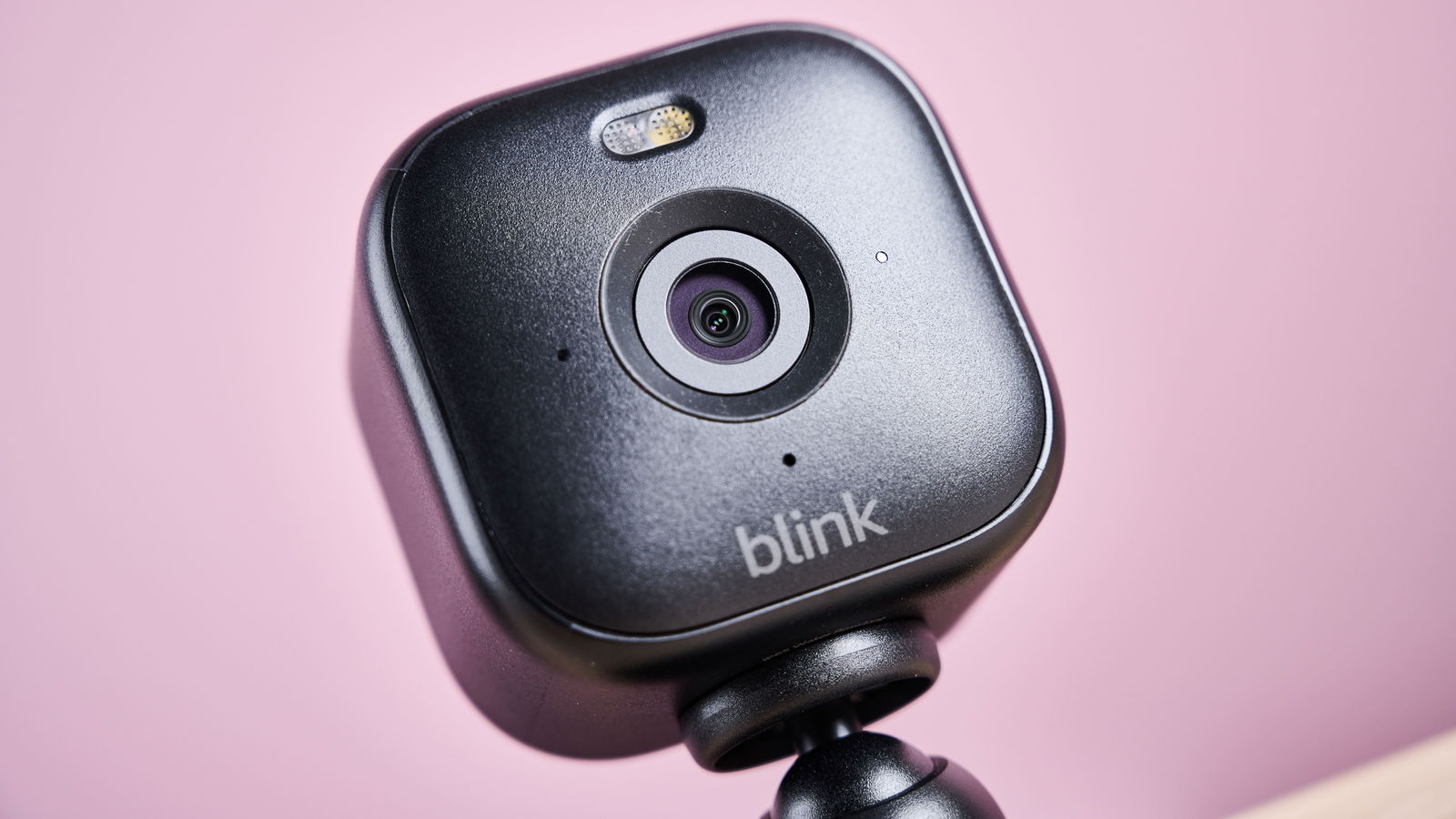 A close-up of the front of the Blink Mini 2, shows the camera and spotlight.