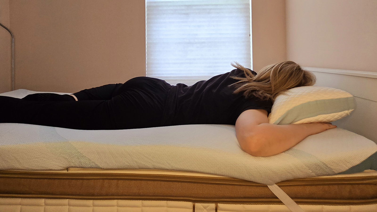 Our mattress tester sleeping on a twin-size Tempur-Adapt + Cooling Topper for the Tempur-Pedic Tempur-Adapt + Cooling Mattress Topper review